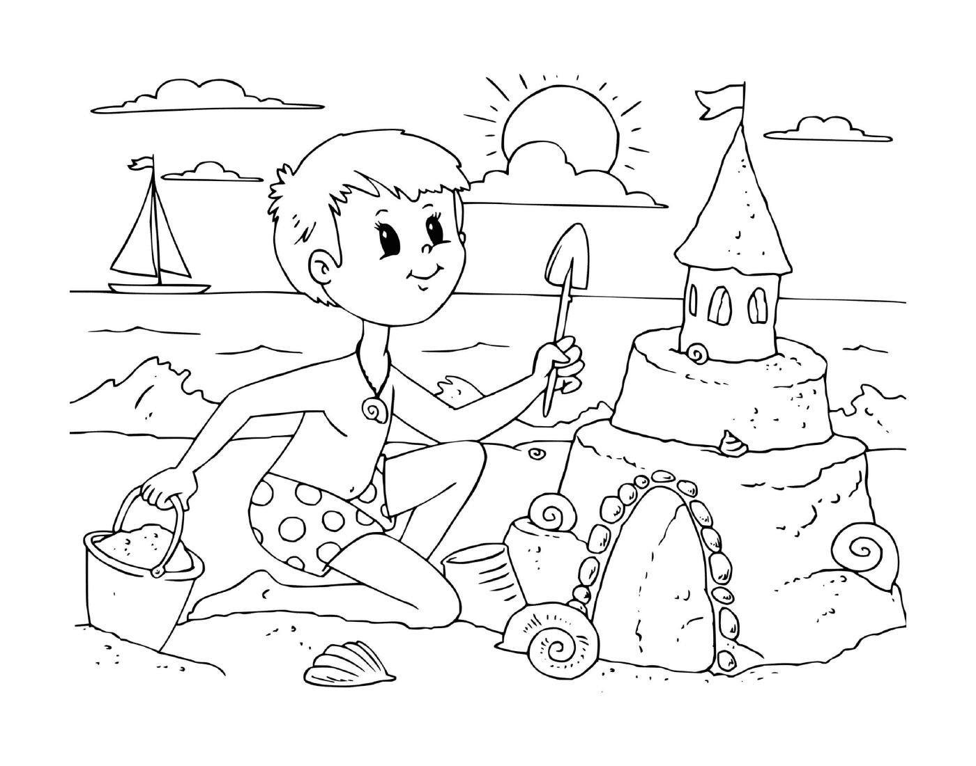  Um menino constrói um castelo de areia na praia 