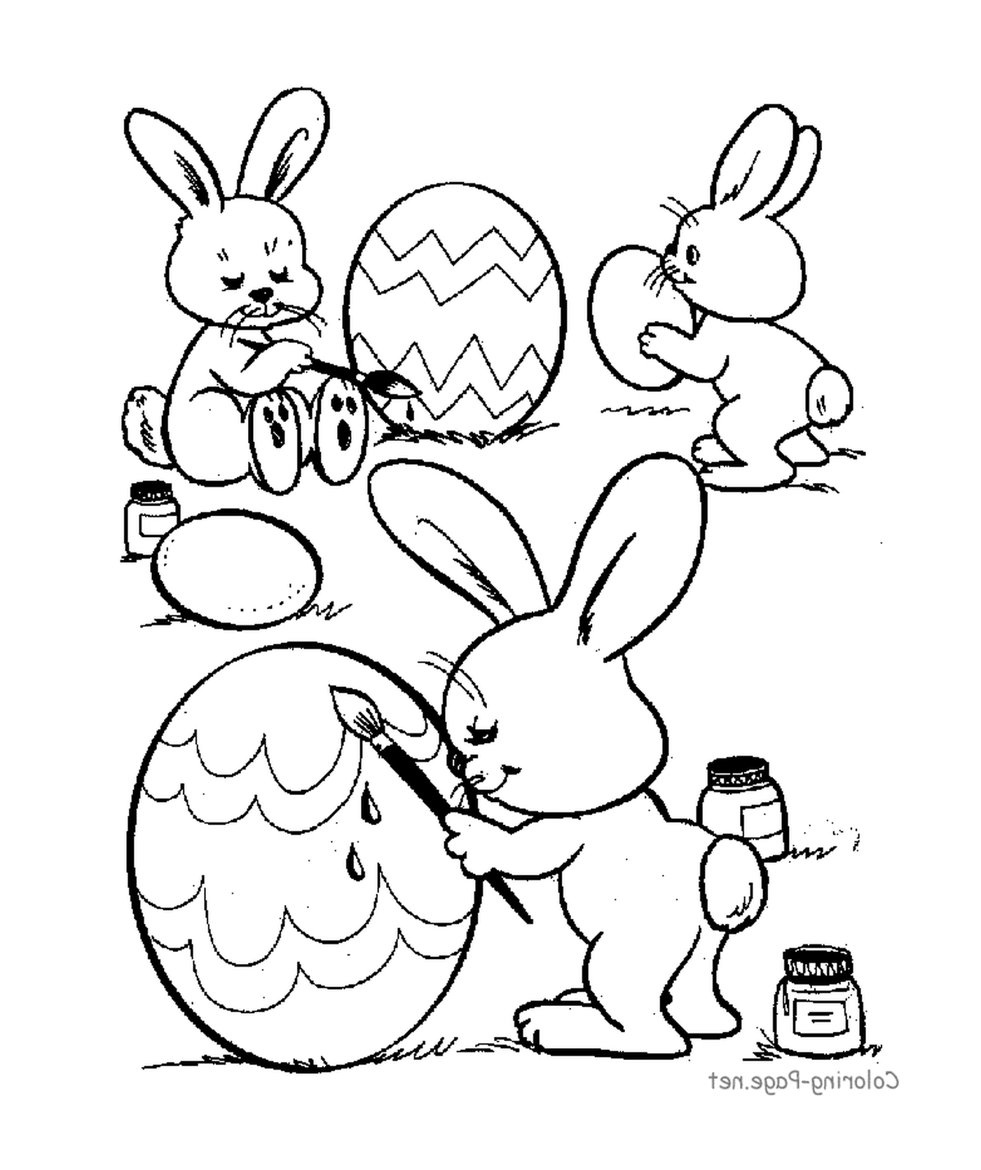  一群兔子在复活节鸡蛋上画画 
