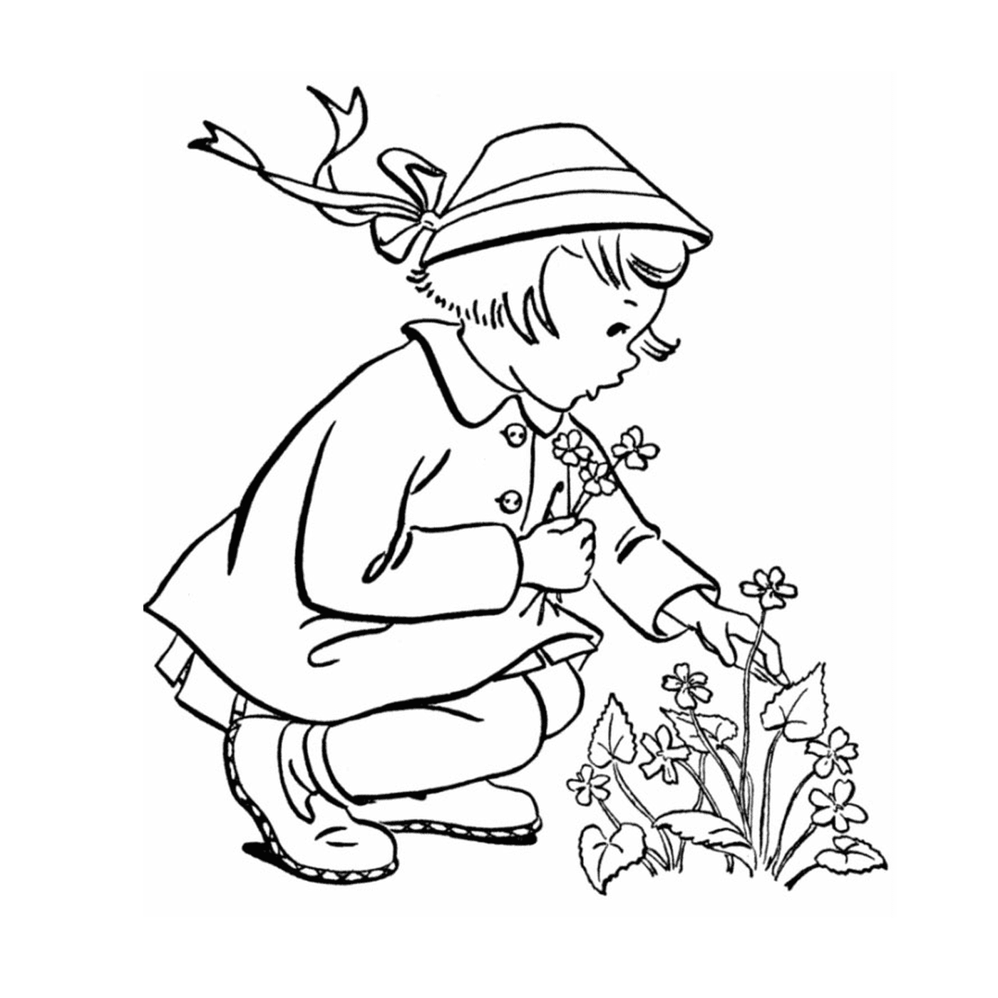  Uma menina de joelhos para plantar uma flor 