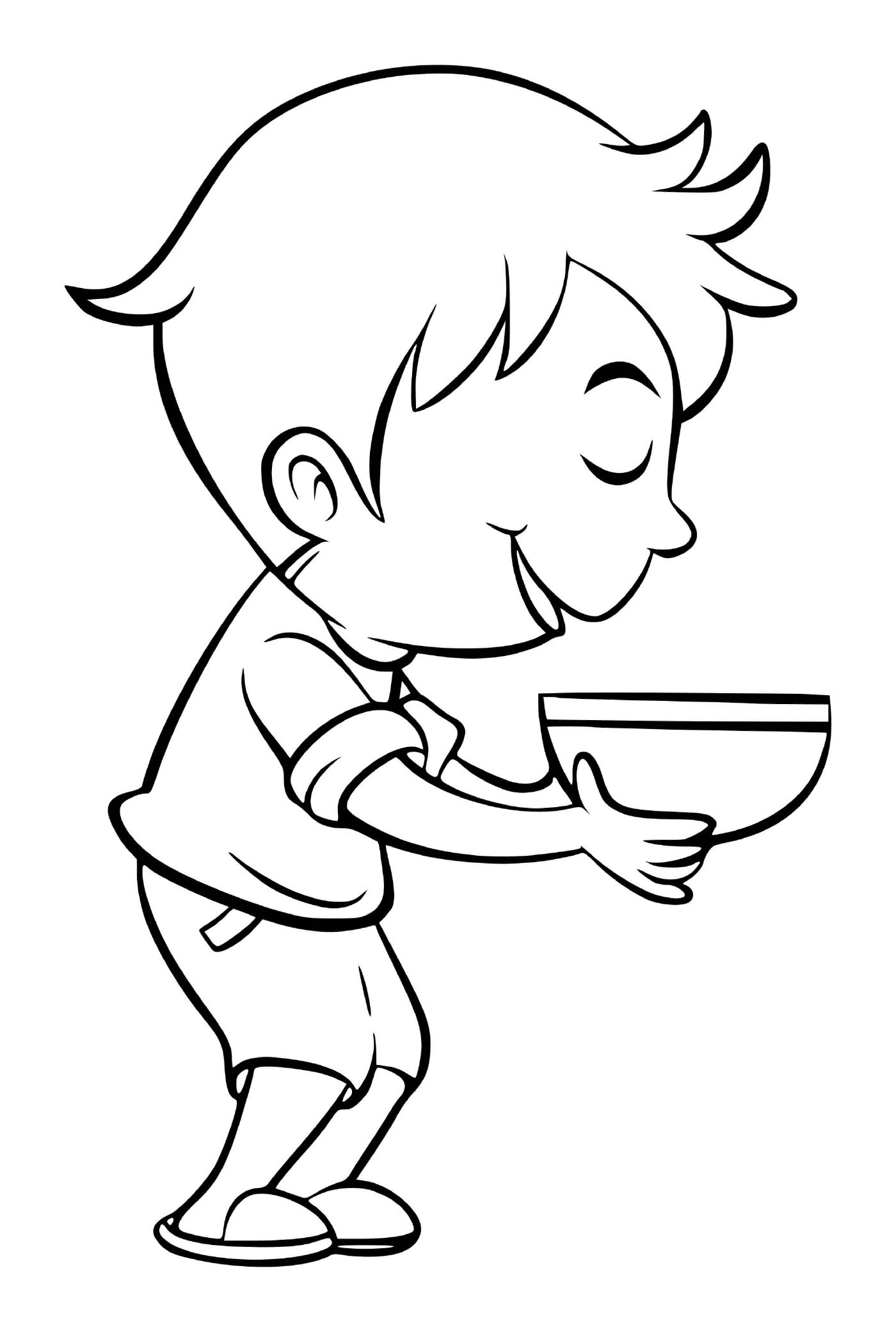  Um menino come sopa de brócolis com prazer 