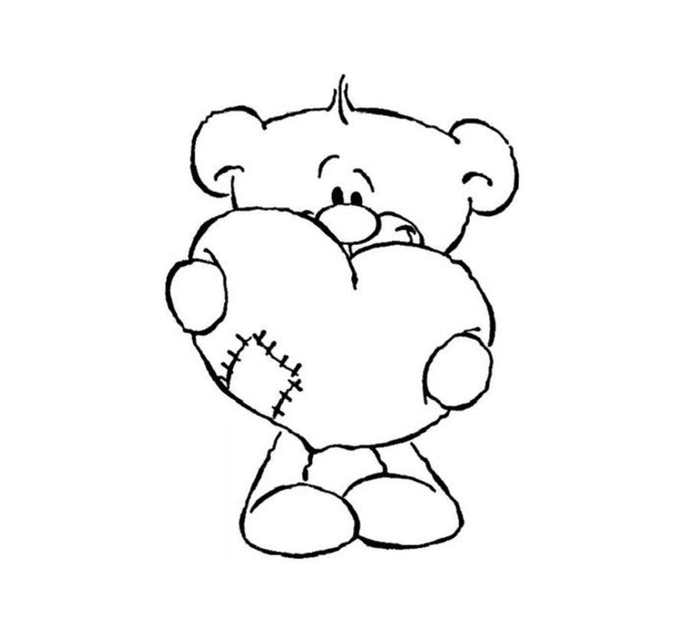  一只泰迪熊手里握着一颗心 